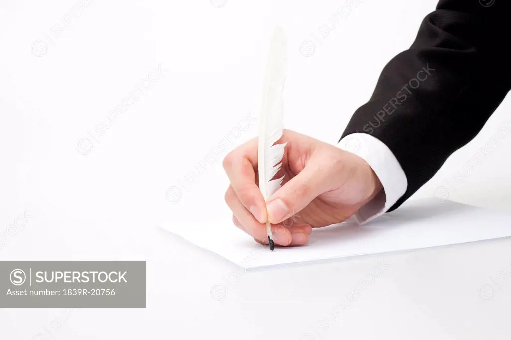 Hand holding quill_pen