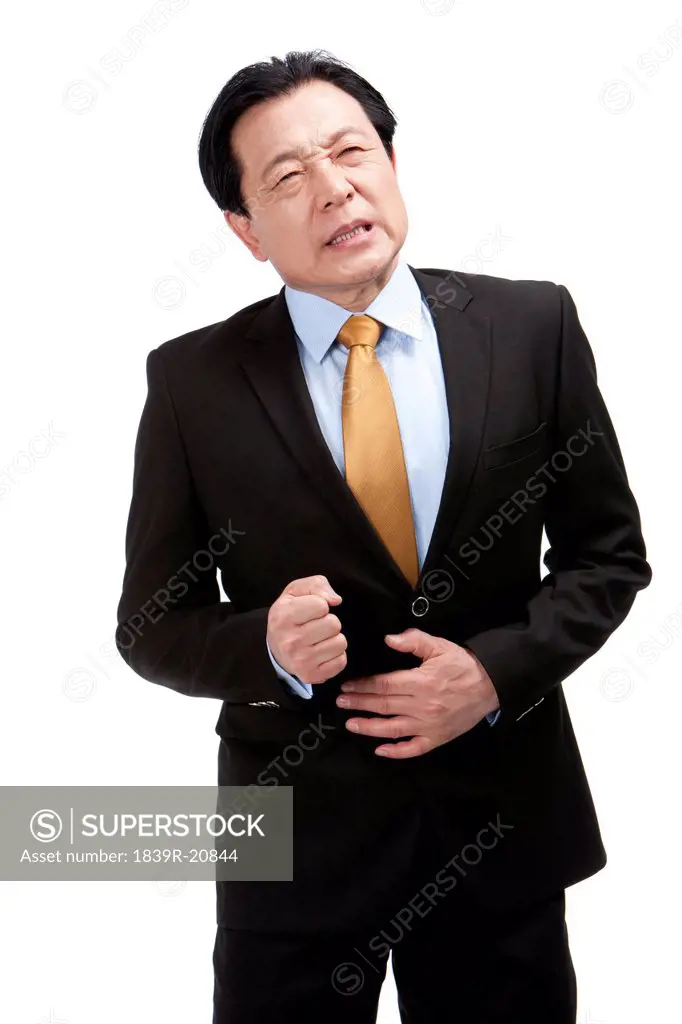 Senior businessman suffering from stomachache