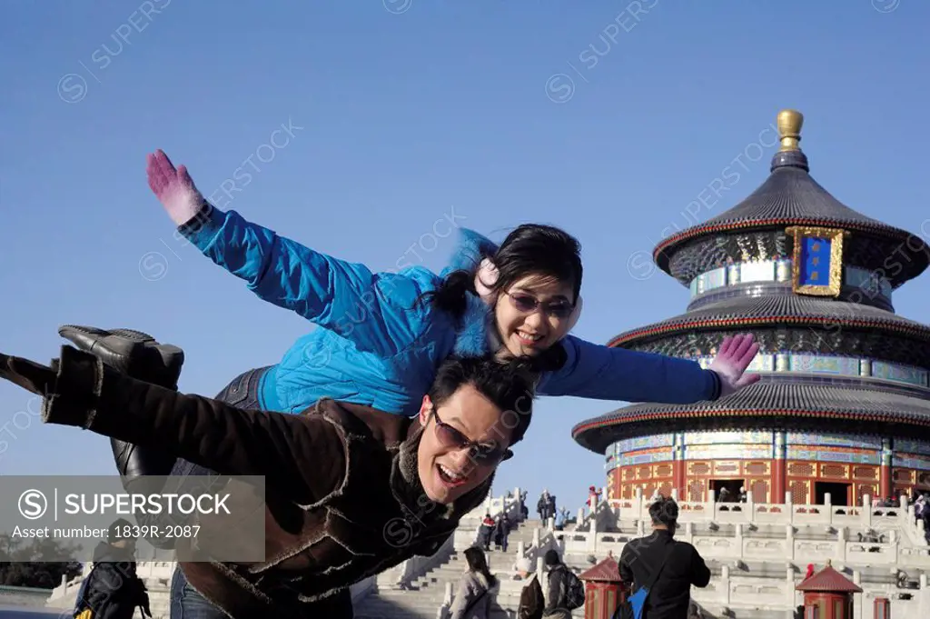 Man Carrying Woman In The Temple of Heaven, Beijing, China