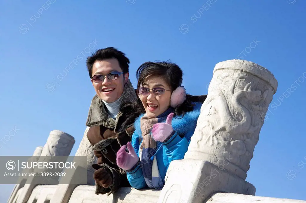 Couple Smiling, Woman Doing Thumbs Up