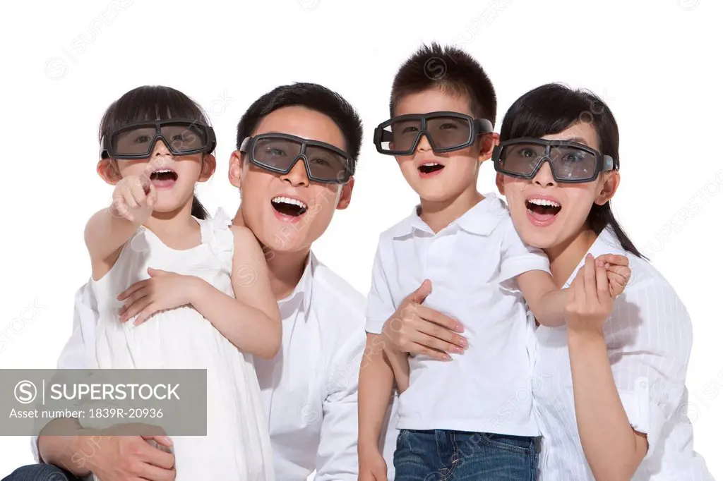 Happy family watching 3D movies
