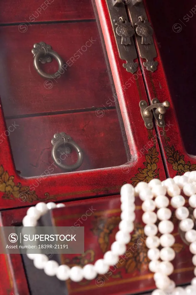 Close_up of Chinese cabinet with pearl necklace