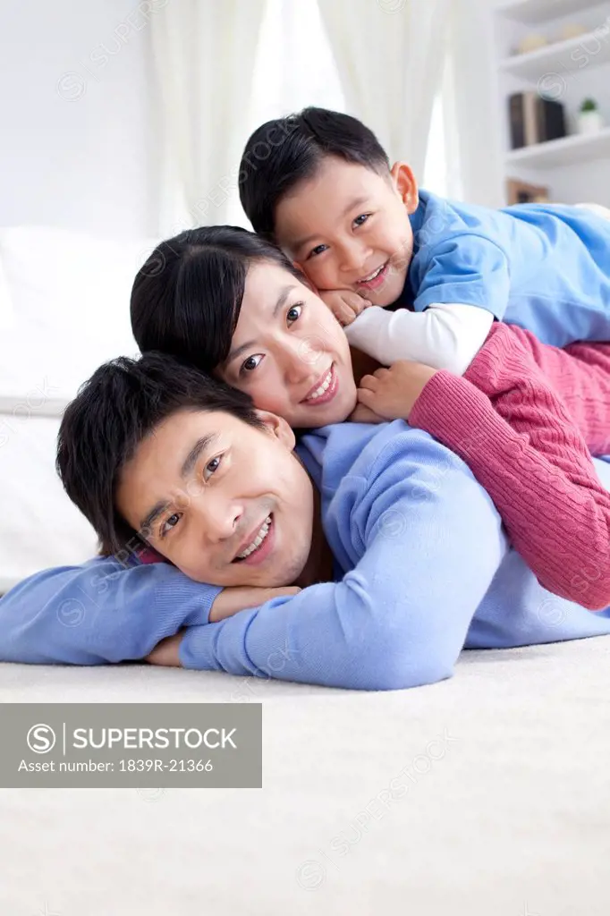 Young Chinese family lying on the floor close_up