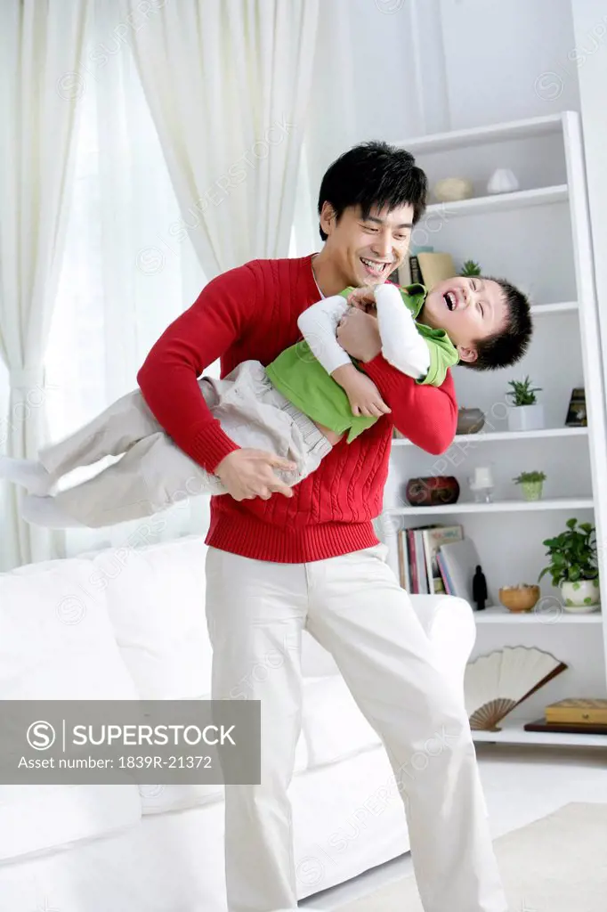 Chinese father playing with son
