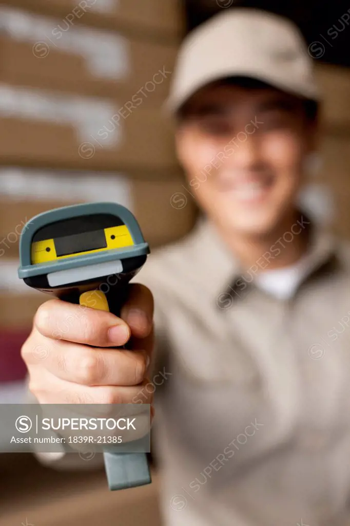 Male Chinese warehouse worker with scanner