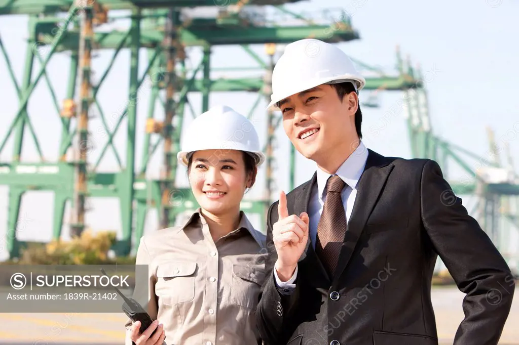 businessman with shipping industry worker in discussion