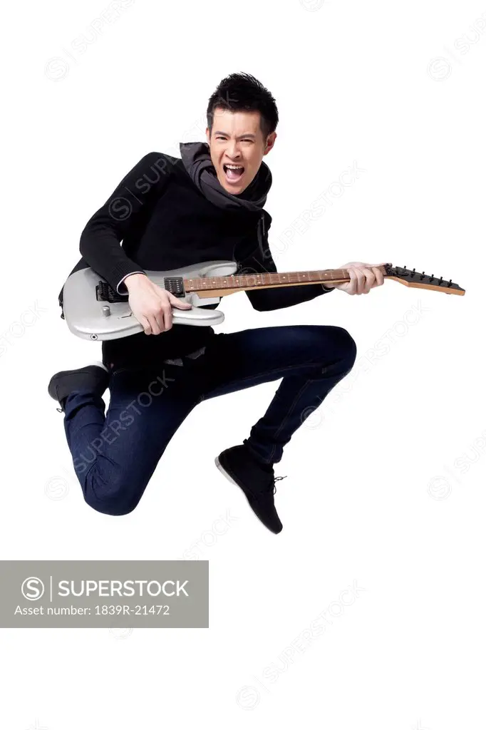 Stylish young man playing guitar