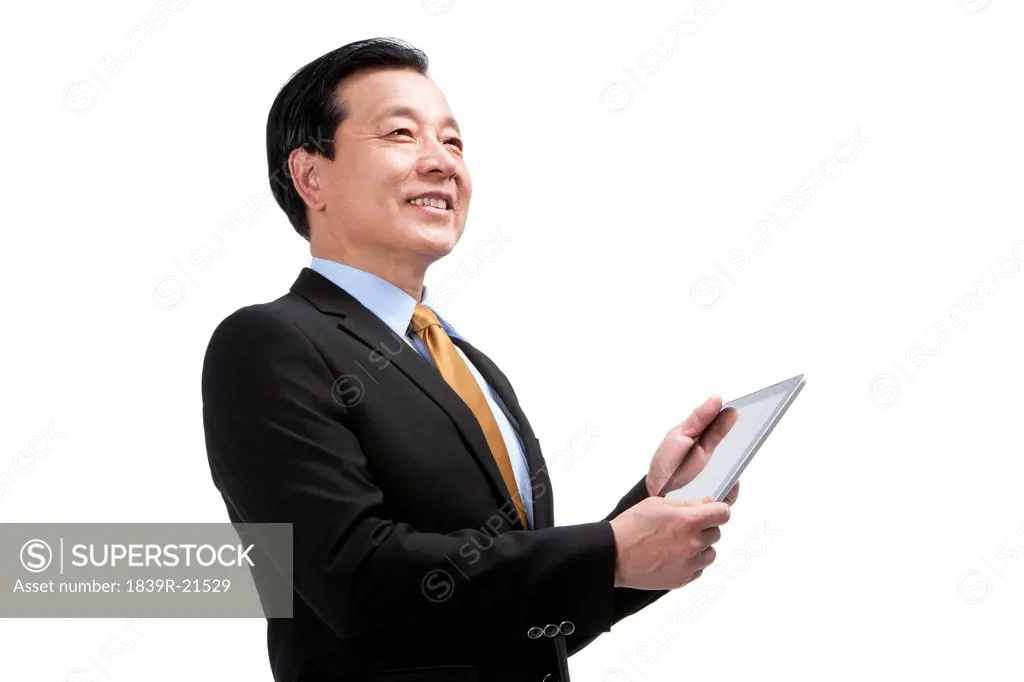 Senior businessman using digital tablet