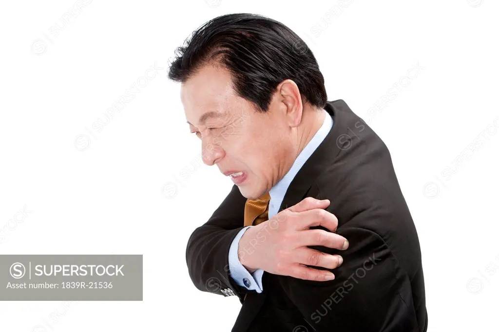 Senior businessman suffering from pain on shoulder