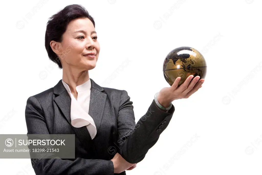 Middle_aged businesswoman holding a globe