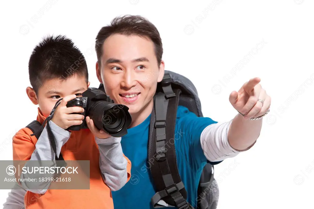 Happy father and son with a camera