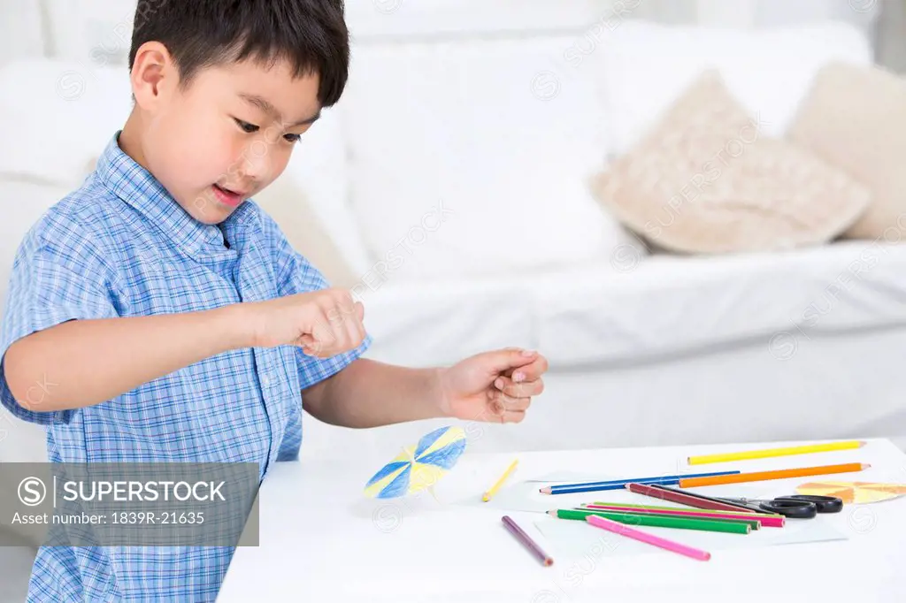 Boy making a paper toy