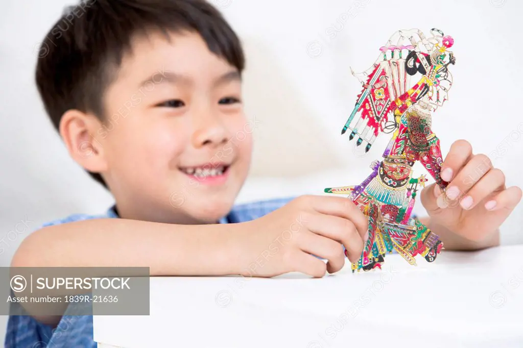 Boy playing a Chinese traditional shadow puppet
