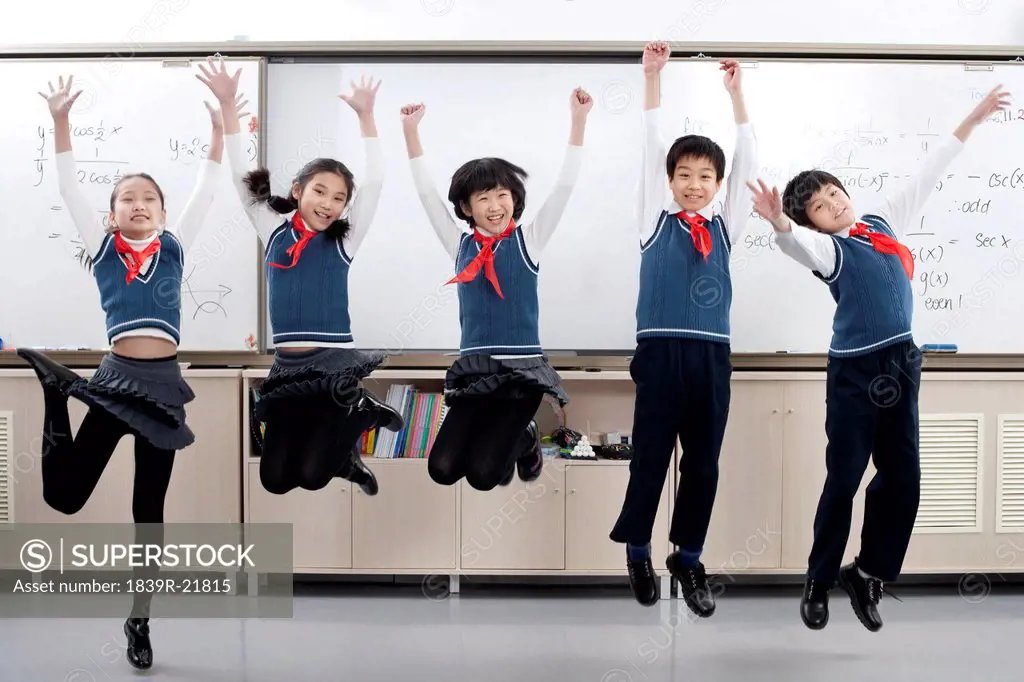 Group of young students jumping in the air