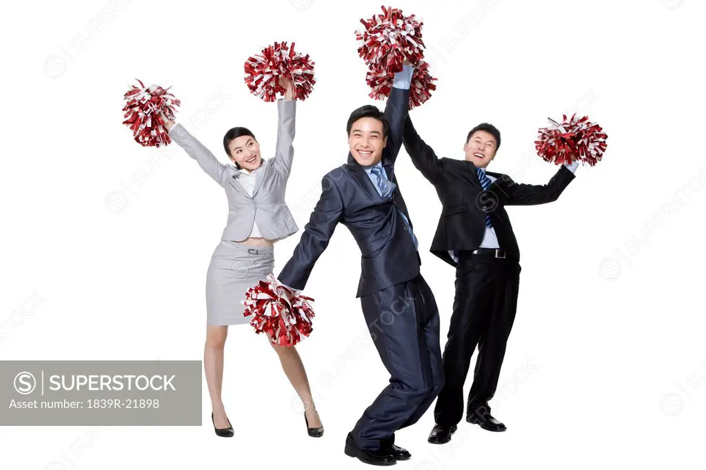 A team of businesspeople cheering with pompoms