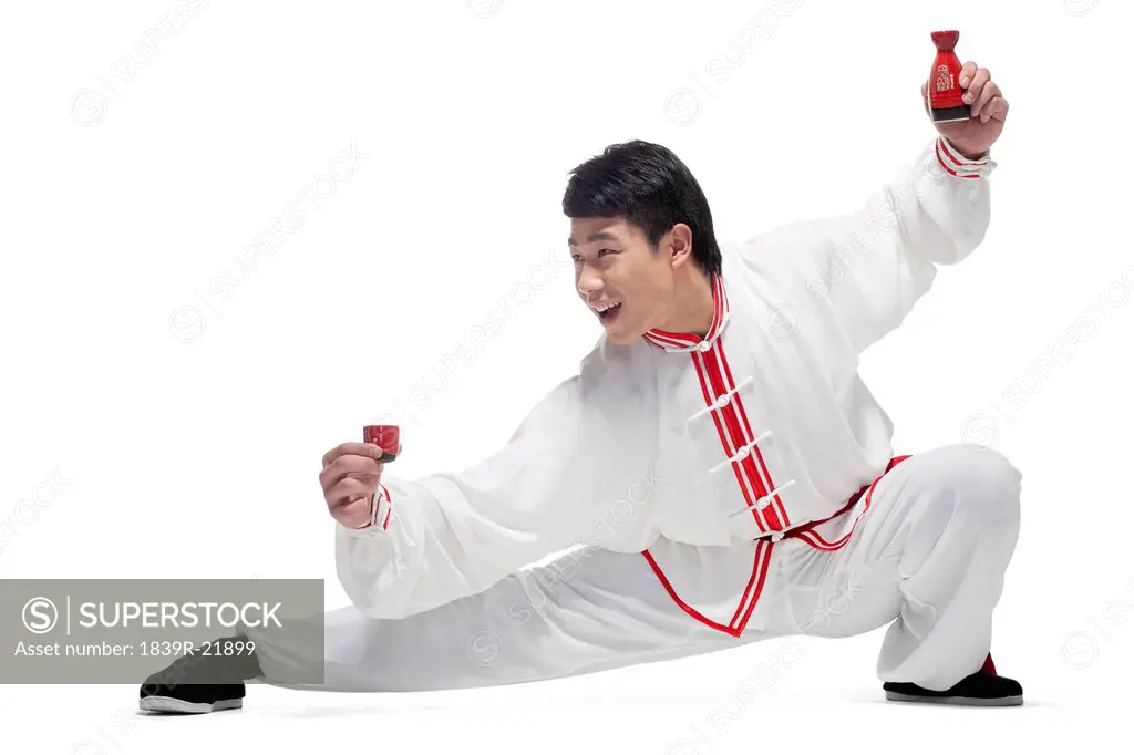Excited Man In Traditional Chinese Clothing Holding up Cup