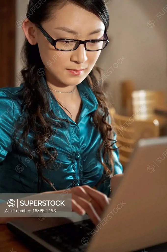 Businesswoman Typing On Laptop Computer