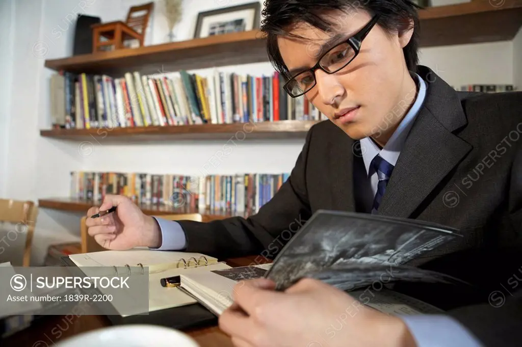Businessman Writing In A Book