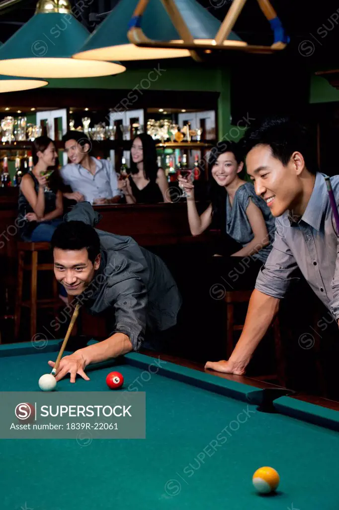 Friends Playing Pool at a Bar