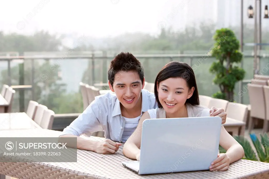 Couple Using Laptop, Outdoors
