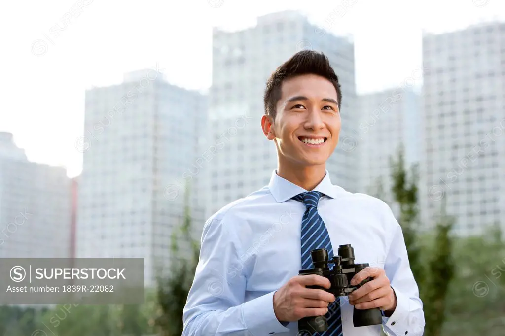 Businessman Holding Binoculars