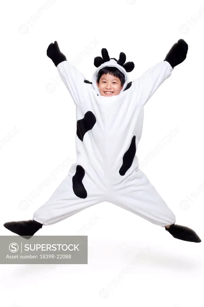 Excited Boy Dressed in a Cow Costume Jumping