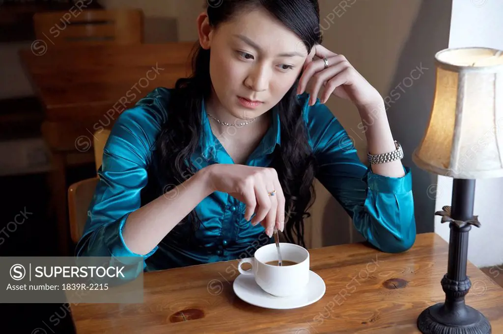 Woman Drinking Coffee Looking Contemplative