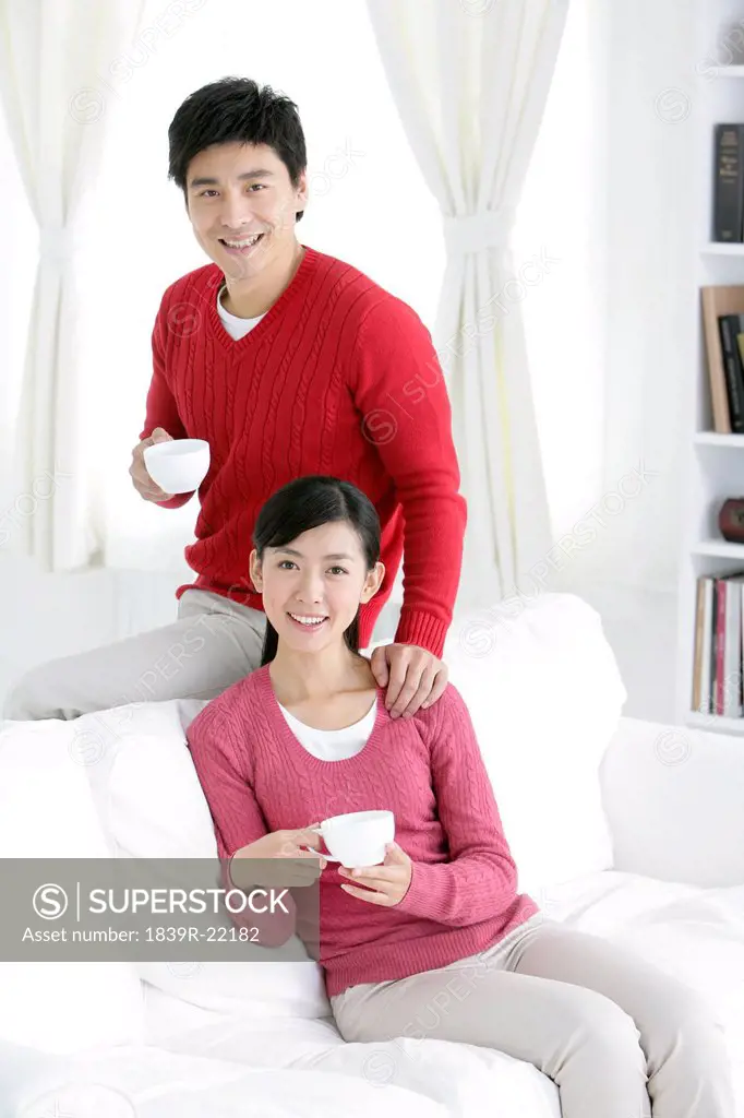 Young Chinese couple with coffee cups