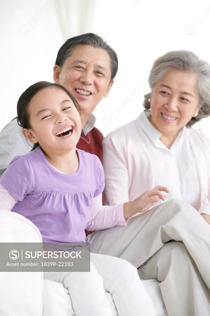 Chinese grandaughter with grandparents in living room