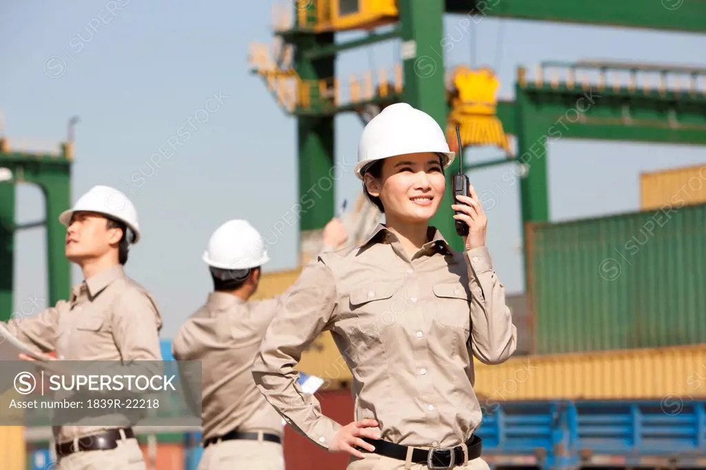 Female shipping worker with walkie_talkie