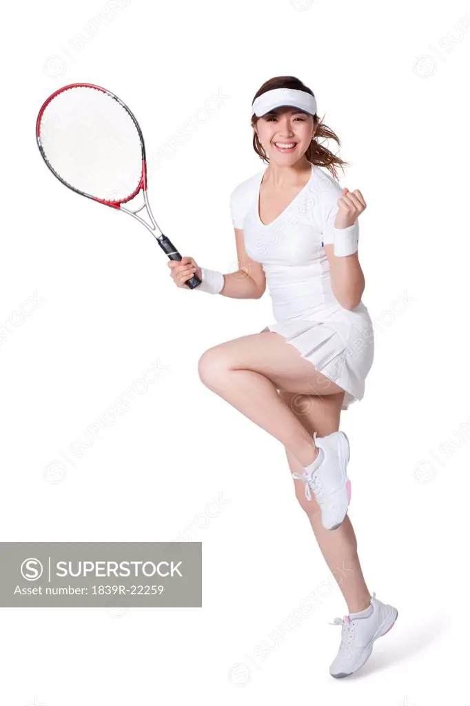 Young woman playing tennis and cheering