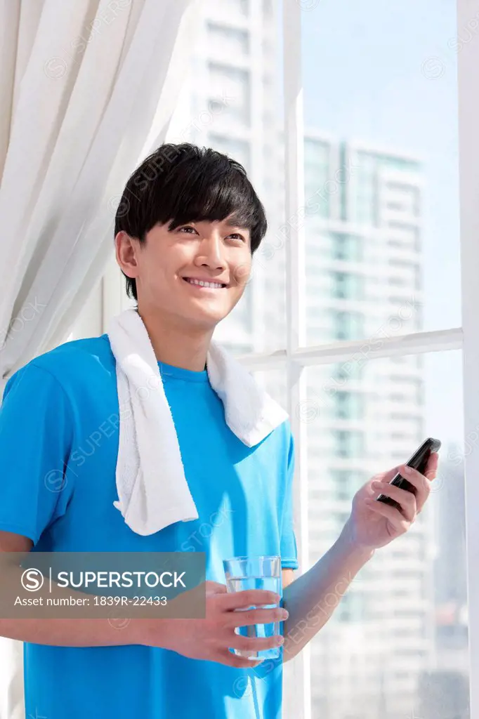 Young man using mobile phone after work_out