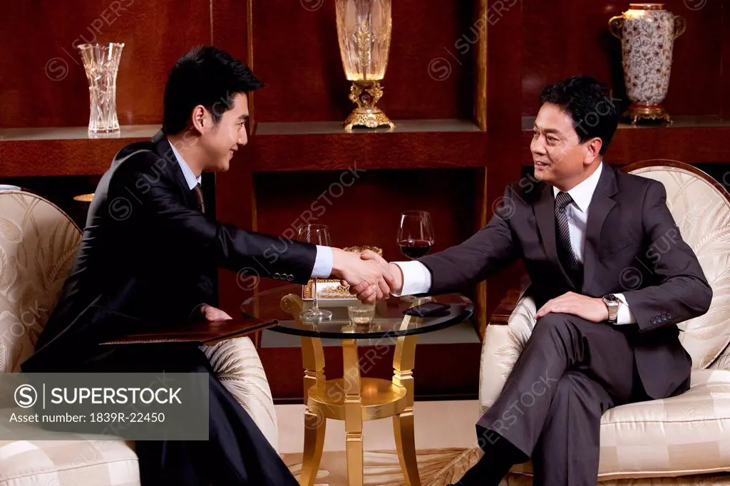 Businessmen shaking hands in a luxurious room