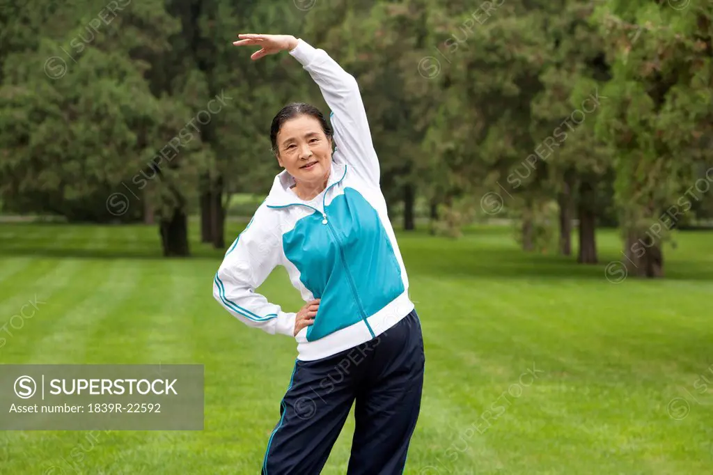 Senior Woman Stretching in a Park