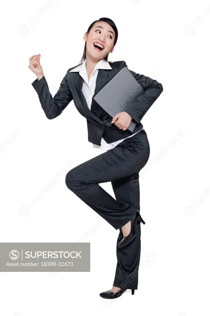 A dancing businesswoman holding a file folder