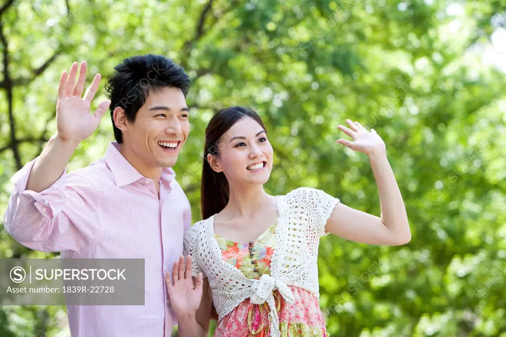 Young Couple Waving