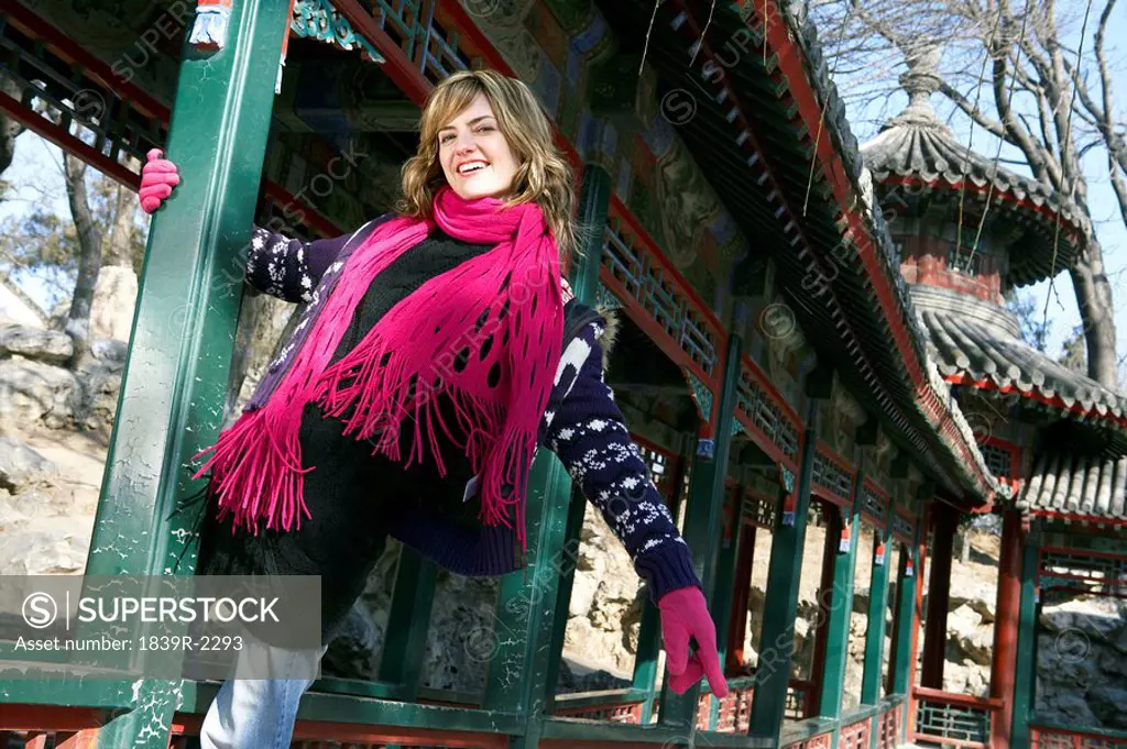 Young Woman Posing In Front Of Traditional Architecture