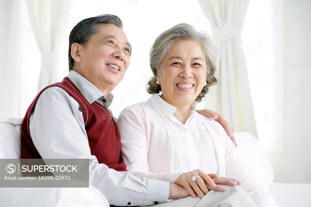 Senior Chinese couple in living room