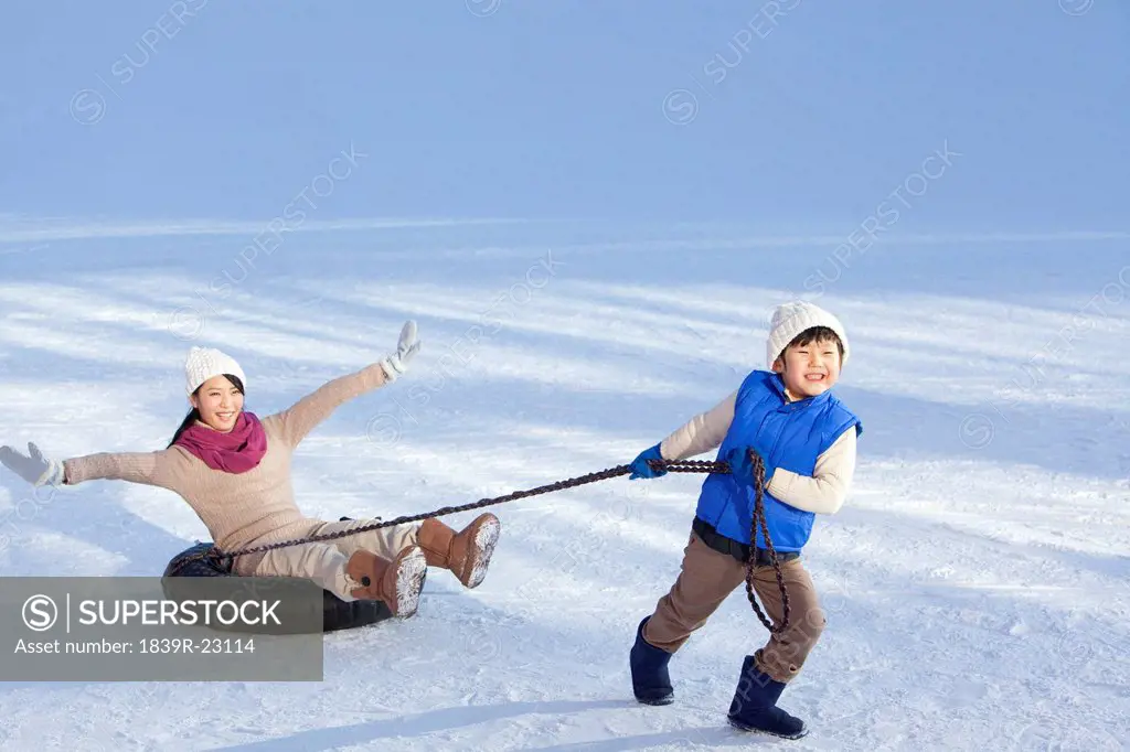 Mother and son having fun in snow