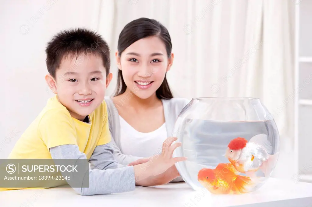 Mother and son with goldfish