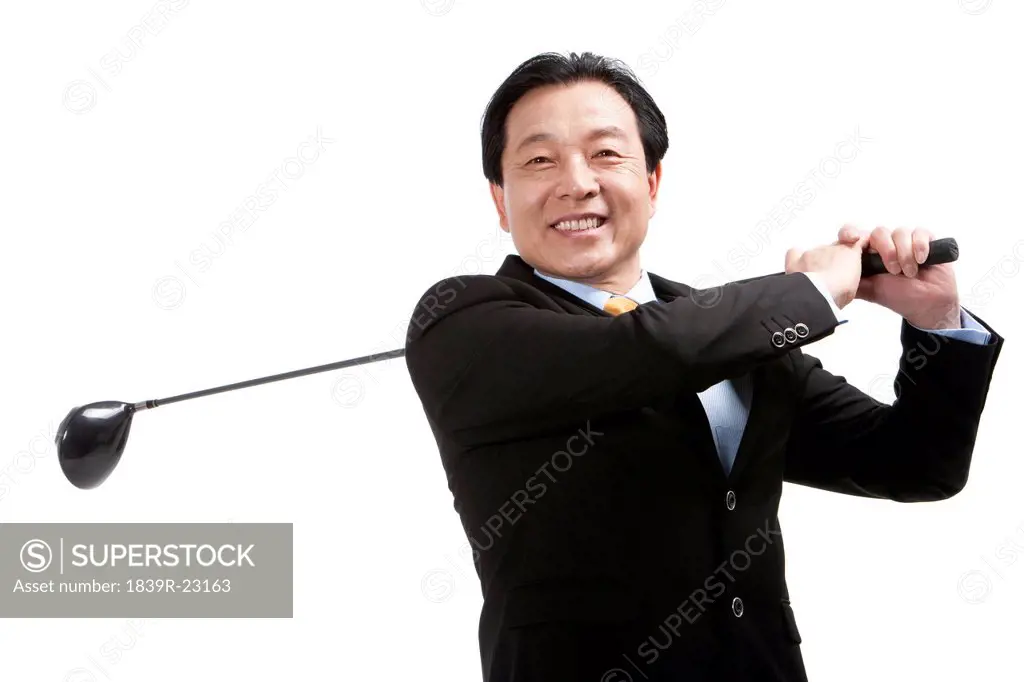 Businessman playing golf