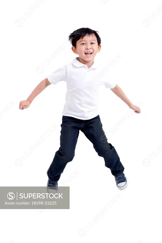 Young boy jumping in mid_air