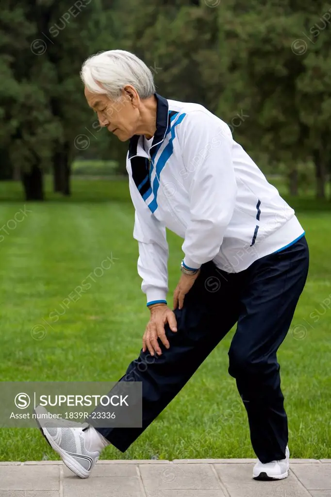 Senior Man Stretching in a Park