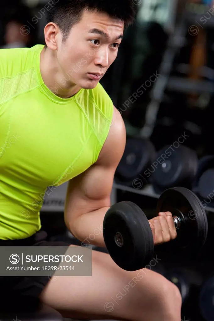 Young Man Lifting Weights