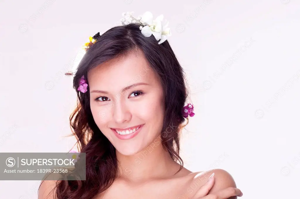 Portrait of a Beautiful Young Woman with Flowers in her Hair