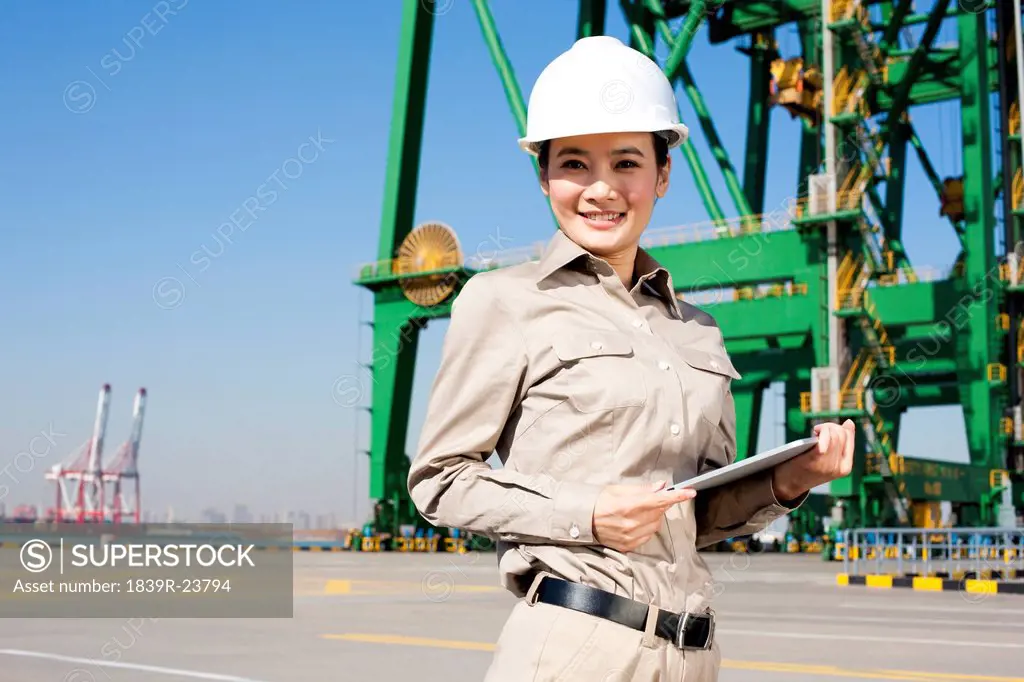 Female shipping industry worker with clipboard