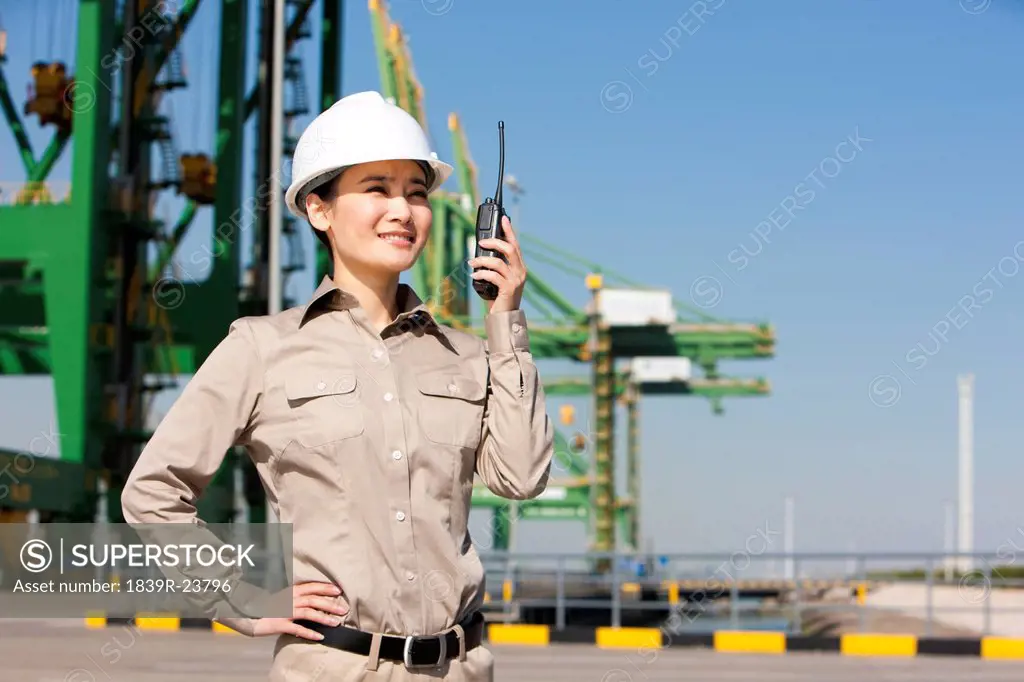 Female shipping industry worker with walkie_talkie