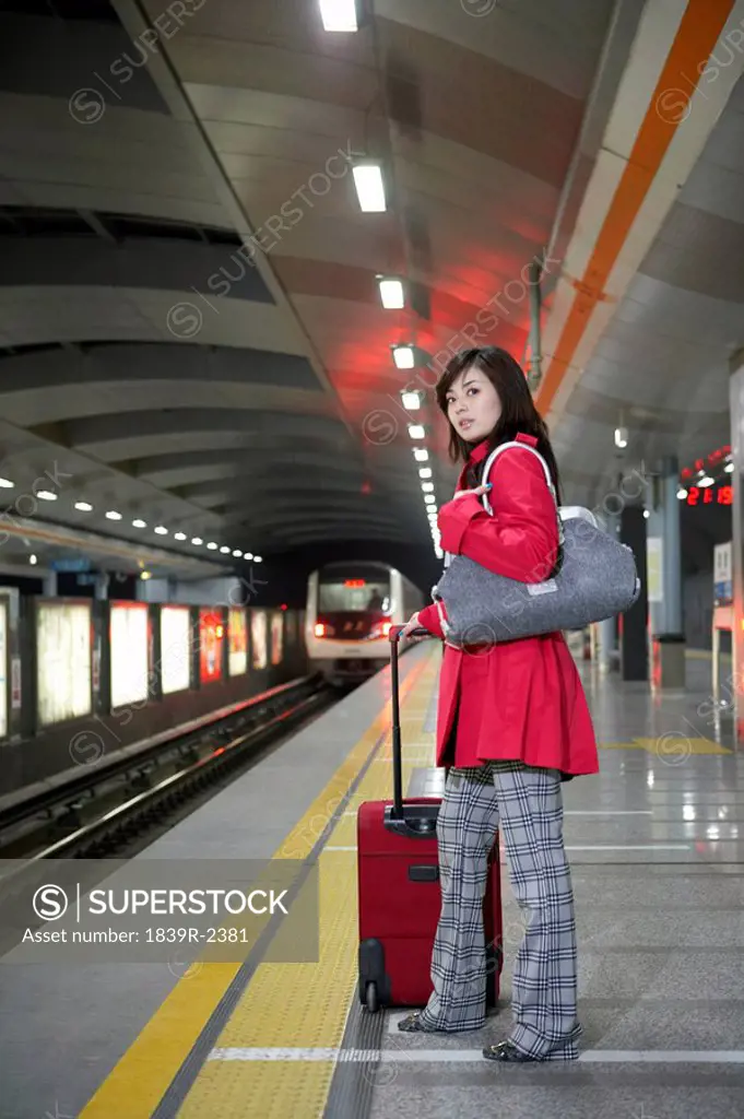 Woman Waiting For Train At Station