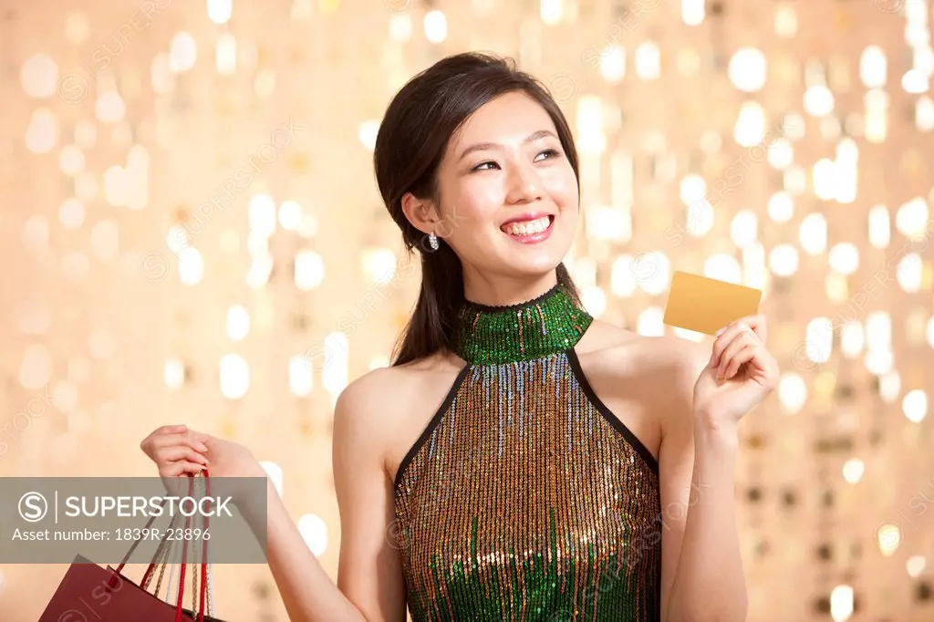 Stylish young woman going shopping with crdit card