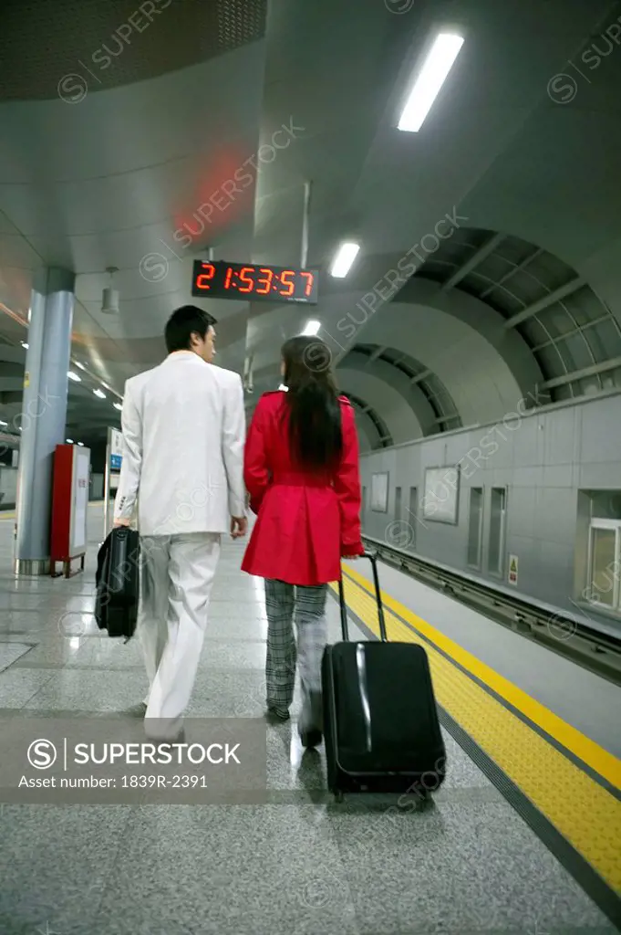 Couple Walking In Train Station